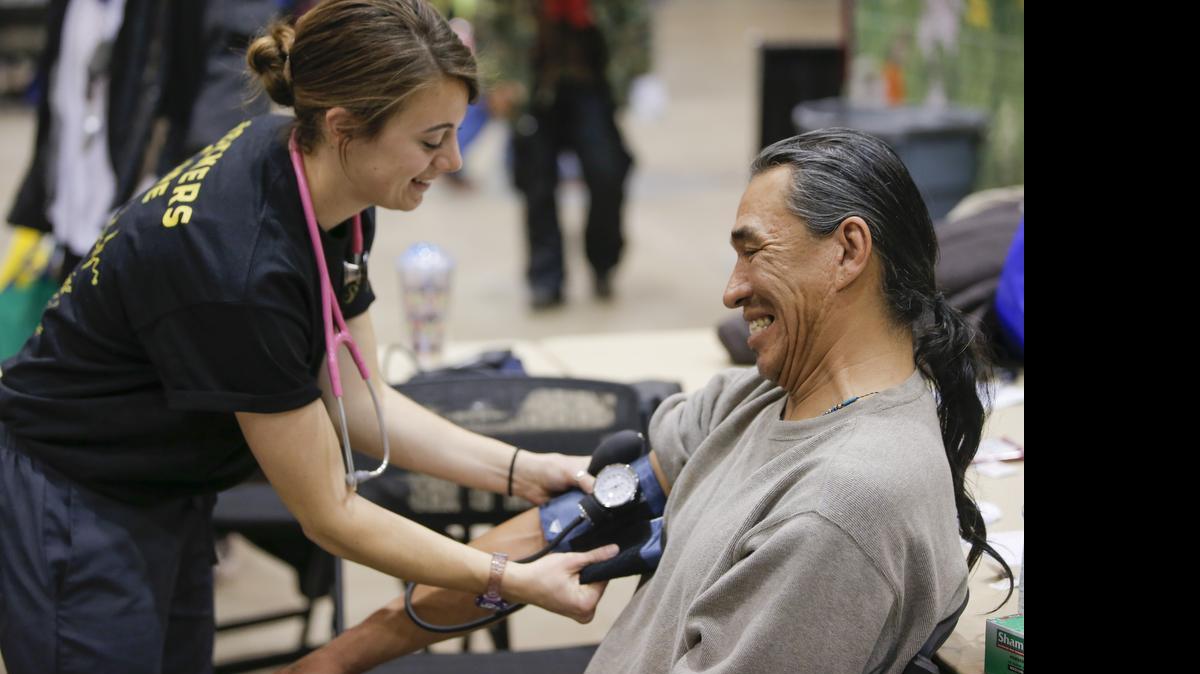 
A man undergoes a health screening with the help of Ashley Leckliter from the Wichita State College of Health Professions during the Point-In-Time Homeless Count & Services Event at Century II in January. The event offered a variety of services to the homeless population in Wichita.
