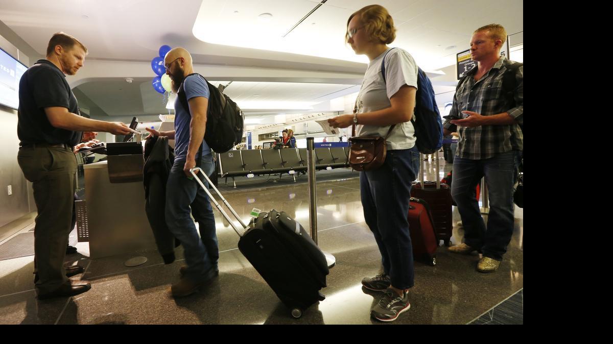 
Passengers on United Flight 6399 board the flight that became the first to depart the new Dwight D. Eisenhower National Airport. (June 3, 2015) 
