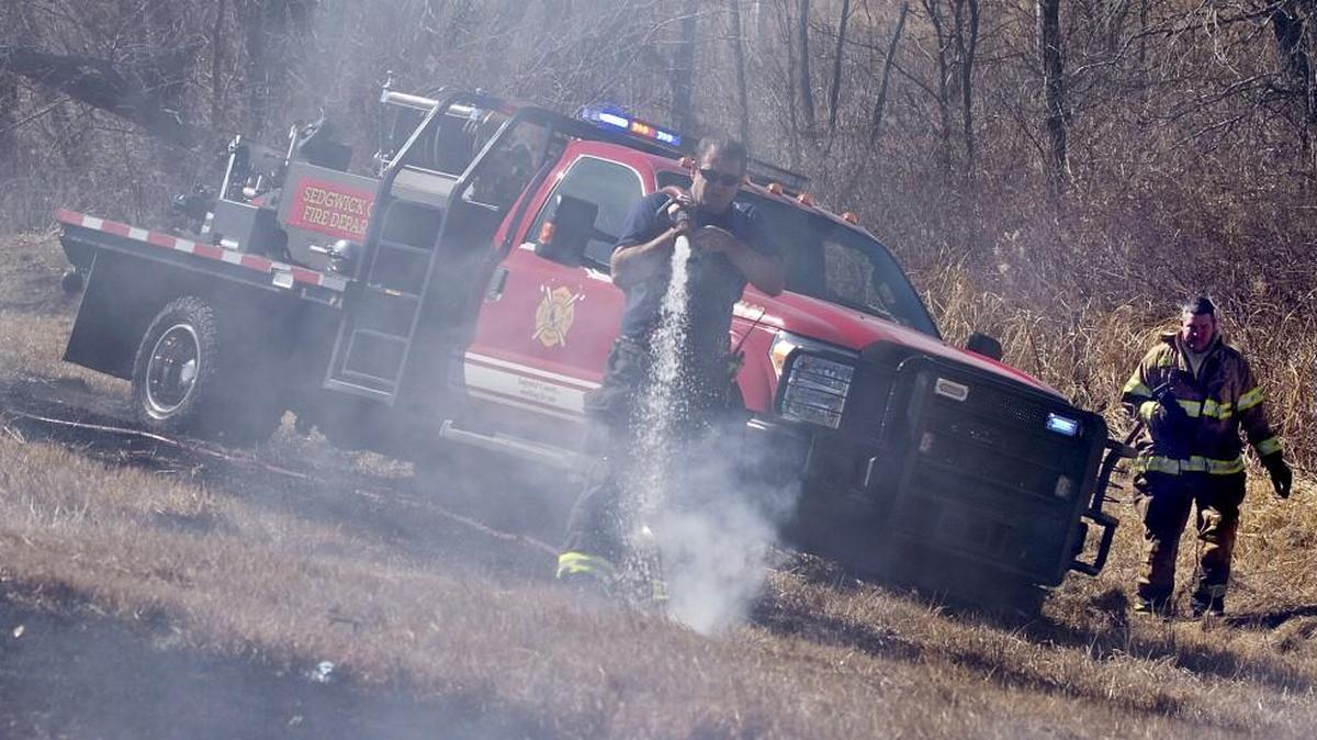 Sedgwick County firefighters douse a series of grass fires along K-42 in southwest Sedgwick County in 2014.