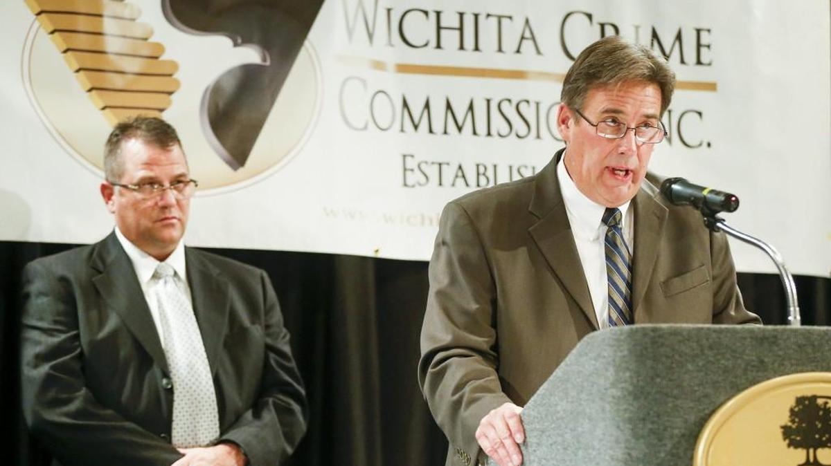 Retired Sedgwick County Sheriff’s Detective Ron Goodwyn, right, receives the Law Enforcement Officer of the Year Award from Sheriff Jeff Easter at the Wichita Crime Commission awards banquet Wednesday night. (Oct. 21, 2015)