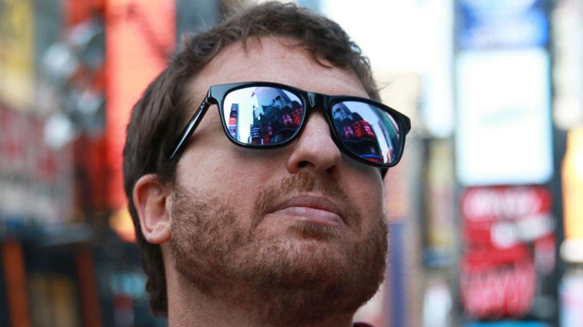 Oliver Morrison, trying out EnChroma sunglasses, in Times Square. The sunglasses promise color for the colorblind.