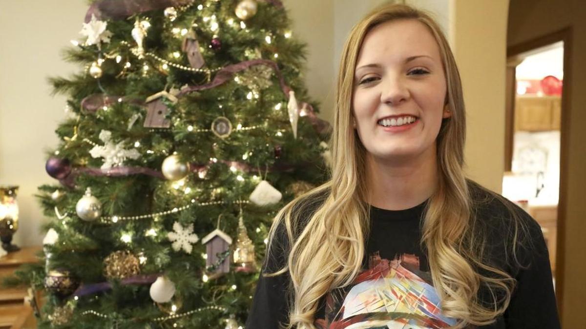 Mallory Adams stands in front of her family's Christmas tree in her home in Wichita. Adams recently returned from the mission field and was unable to watch the three most recent Star Wars movies despite being a longtime fan.