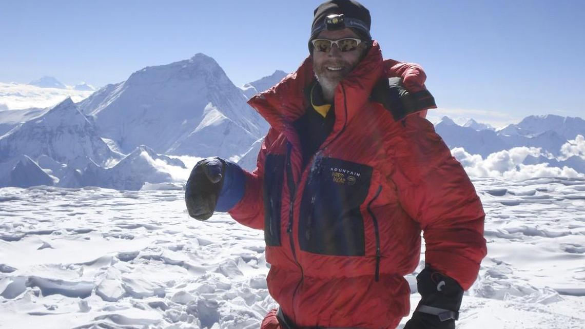 Glenn Nyberg reaches the peak of Cho Oyu in 2014. Mount Everest can be seen in the background. Cho Oyu is the sixth-highest mountain in the world.
