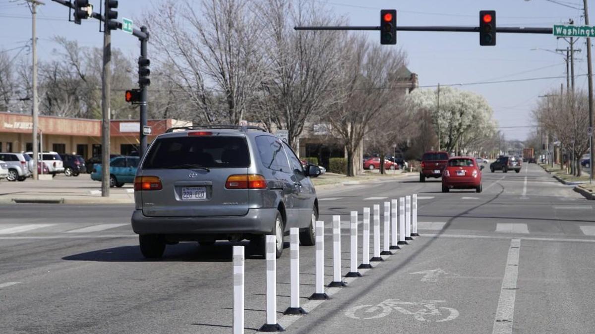 Bike lanes at First and Washington are now sporting vertical barriers after Yellowbrick Street Team prompted the project using toilet plungers. (March 8, 2017)