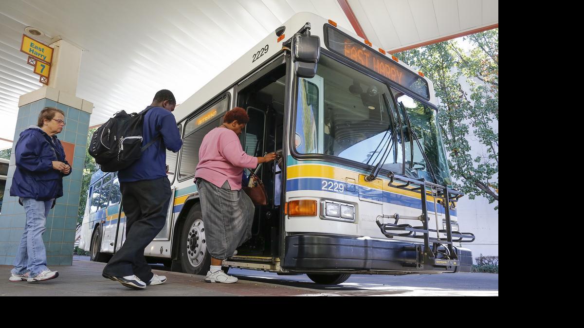 
Riders board a bus at the Wichita Downtown Transit Center. The bus system faces a $2 million shortfall starting next year.
