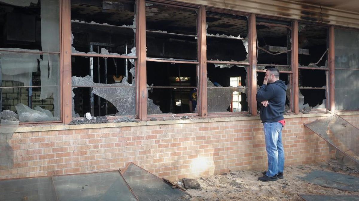 Kenny Pedigo, strength and conditioning coach for Olympic boxer Nico Hernandez, looks into the fire-damaged Northside Boxing Academy on the morning of Nov. 5. Local Freddy’s restaurants will hold a fundraiser on the evening of Dec. 6 to help rebuild the gym.