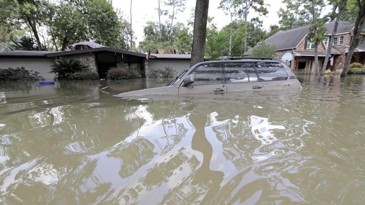 A car is submerged in floodwater in the aftermath of Hurricane Harvey in Houston. State officials in Kansas are warning consumers to watch out for flood-damaged vehicles that may be making their way to Kansas and are being offered well below market value in private sales.