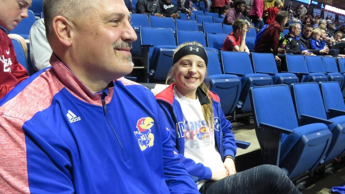 Steve Carvajal and daughter Brooklyn, who live near Springfield, Mo., watch a practice Thursday at the BOK Center in Tulsa. They plan to attend next year’s NCAA weekend in Wichita.