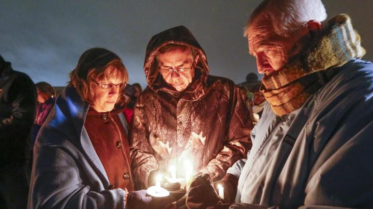 Participants pray during a candlelight vigil for Toni Anderson at the Risen Savior Lutheran Church on Thursday night. (Jan. 19, 2017)