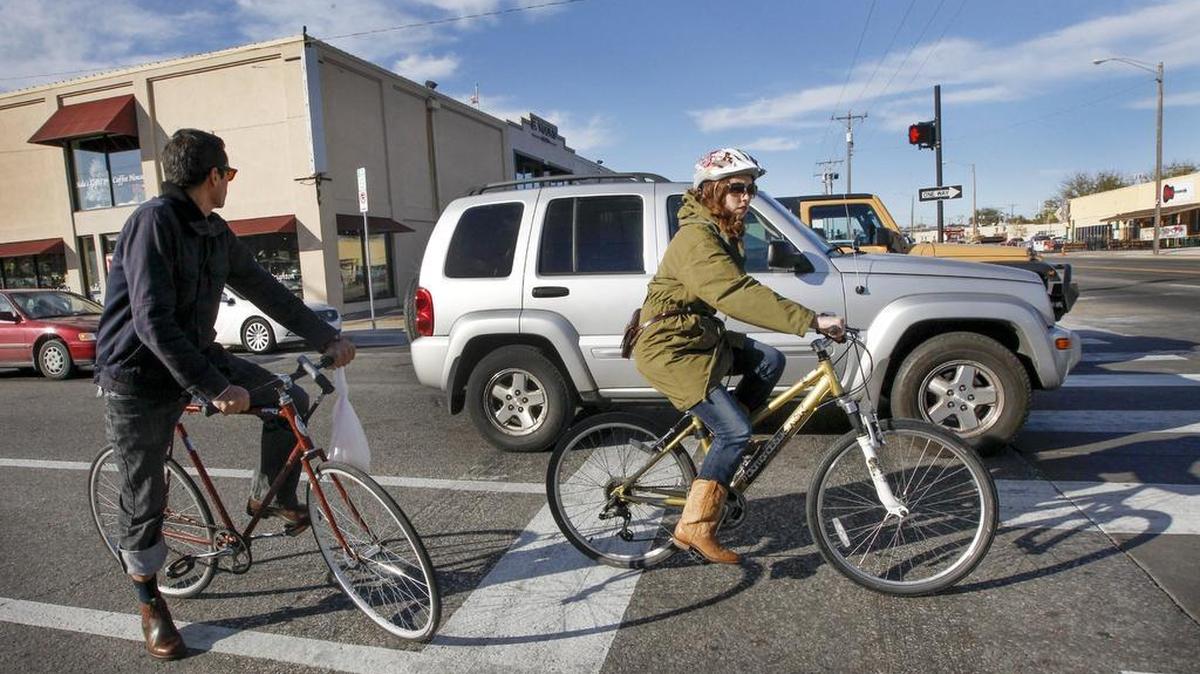 Bicyclists make their way down one of the bike lanes on First Street in downtown Wichita in October.