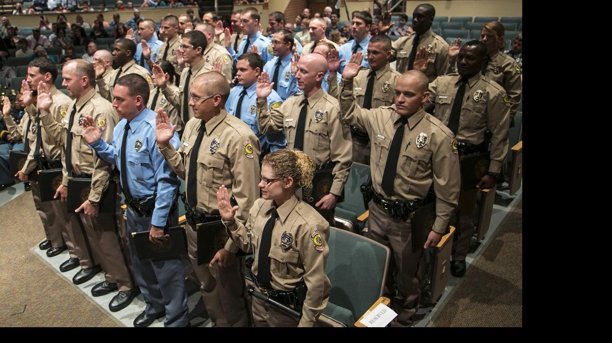 
Eight Sedgwick County sheriff's deputies and 21 Wichita police officers graduate from the Wichita/Sedgwick County Law Enforcement Training Center Friday at Maize South High School. Through 24 weeks of basic academy training, the graduates learn interpersonal communication, policy and procedure, legal issues, computer training, defensive tactics, firearms training and emergency vehicle operations. (June 19, 2015) 
