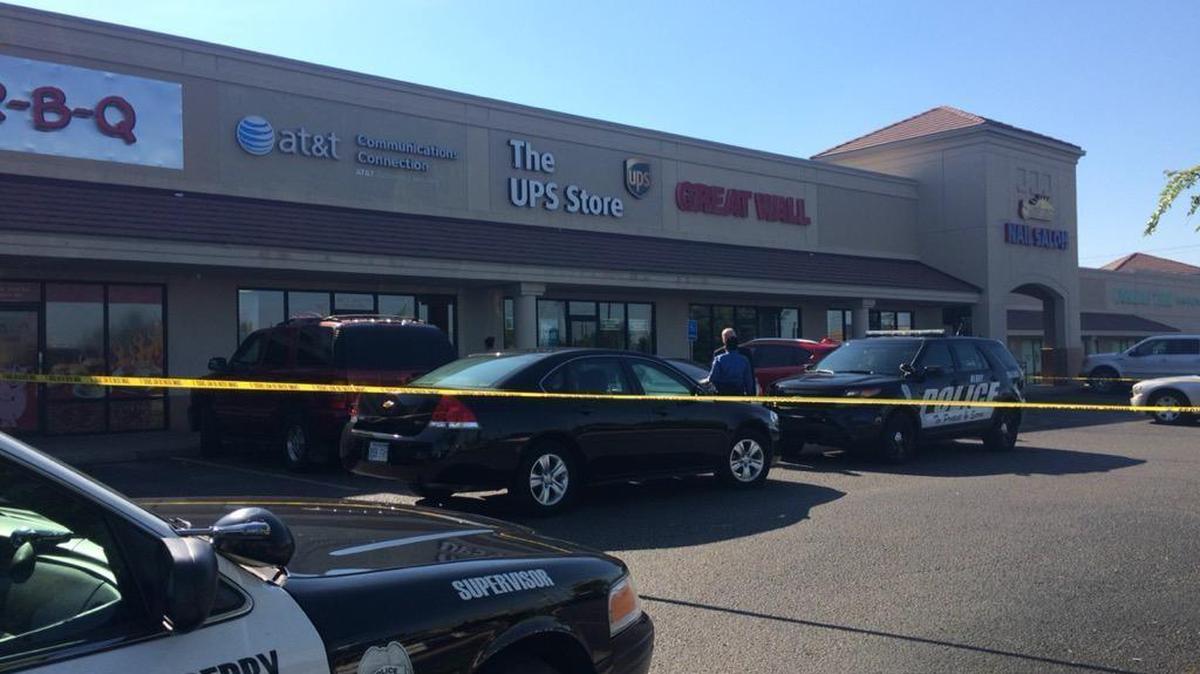 
Police investigate the scene of a shooting Tuesday at an AT&T store in Derby at the intersection of Rock and Madison. 

