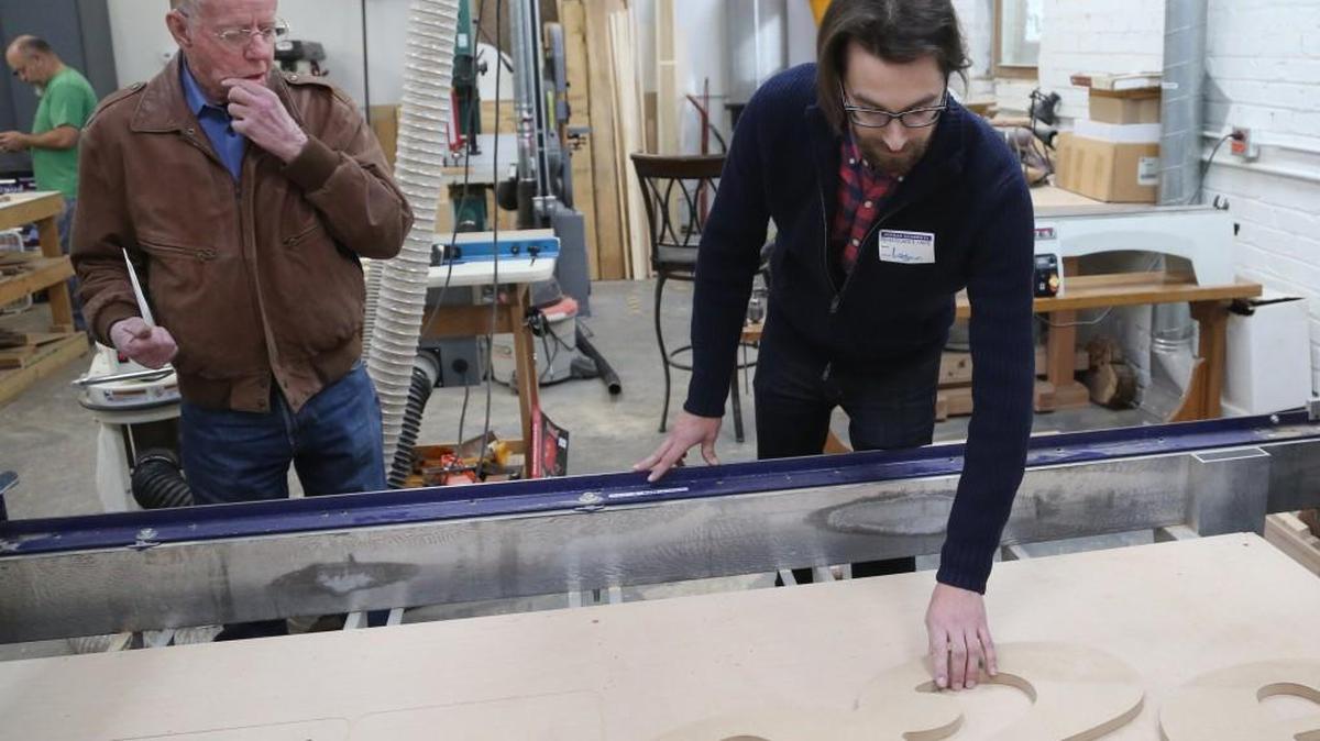 Ivan Rossiter, left, who lost his wood shop in a fire recently, has been given a year’s membership at MakeICT so he can continue his woodworking. Rossiter got a tour of the facilities from Logan Pajunen, MakeICT board president. (Dec. 21, 2016)