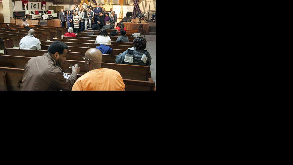 
Durell Gilmore, left, asks Bobby Anderson to add his signature to a letter the Sunflower Community Action group will be sending to Sedgwick County District Attorney Marc Bennett. A news conference was called after the grand jury announcement that police officer Darren Wilson would face no charges in Ferguson, Mo. (Nov. 25, 2014)
