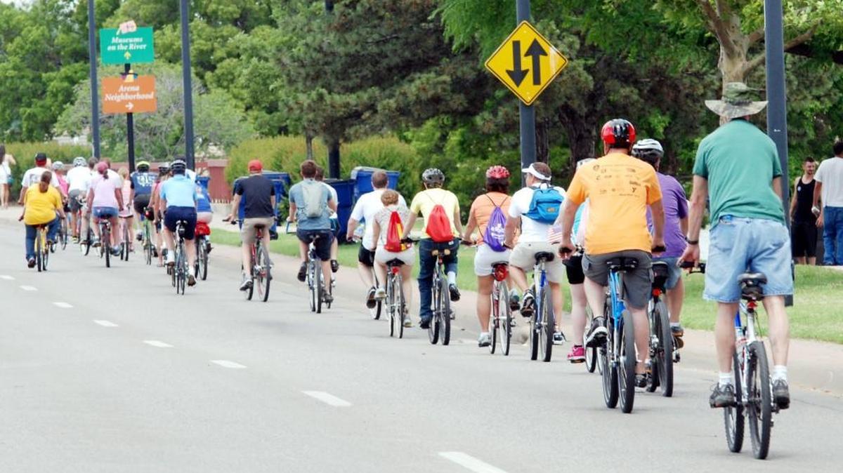 Riverfest cyclists travel on McLean Boulevard as they attempt to break a Guinness World Record for a moving line of bicycles in 2014.