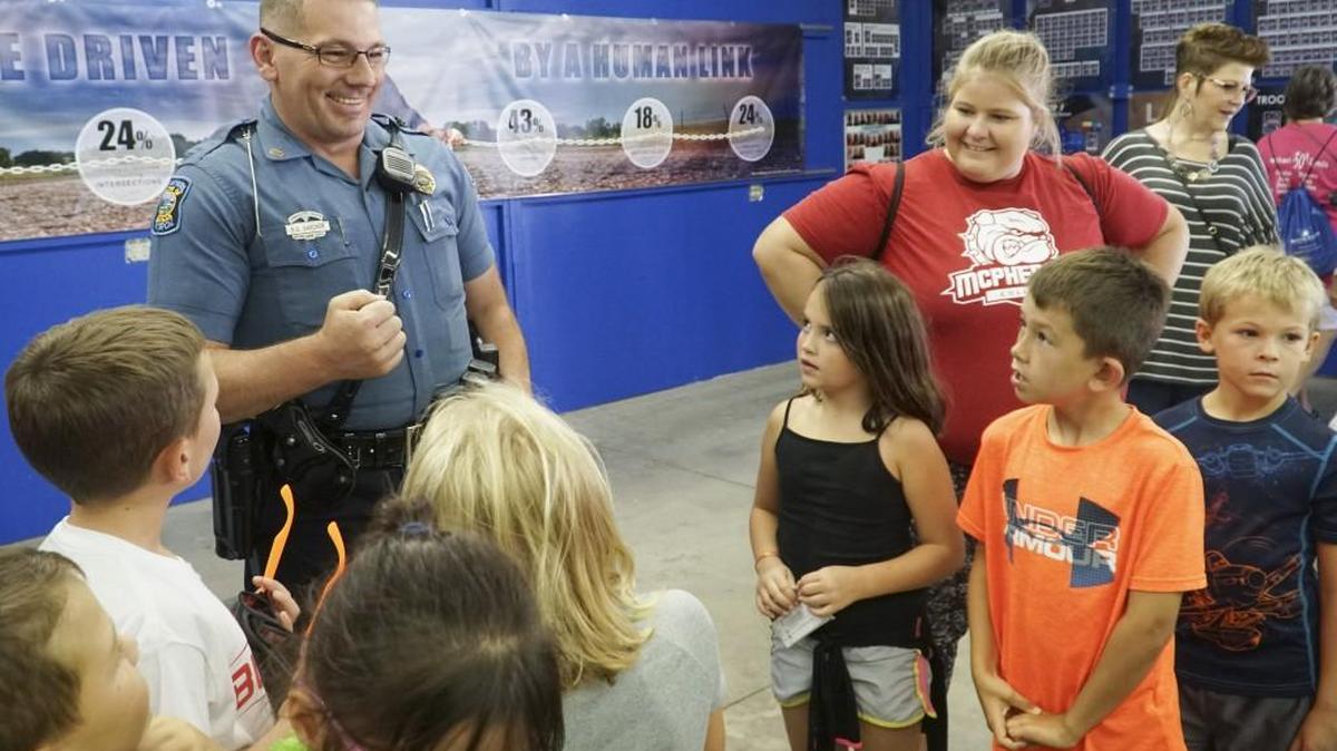 Kansas State Trooper Ben Gardner talks to children at the Kansas State Fair in September.