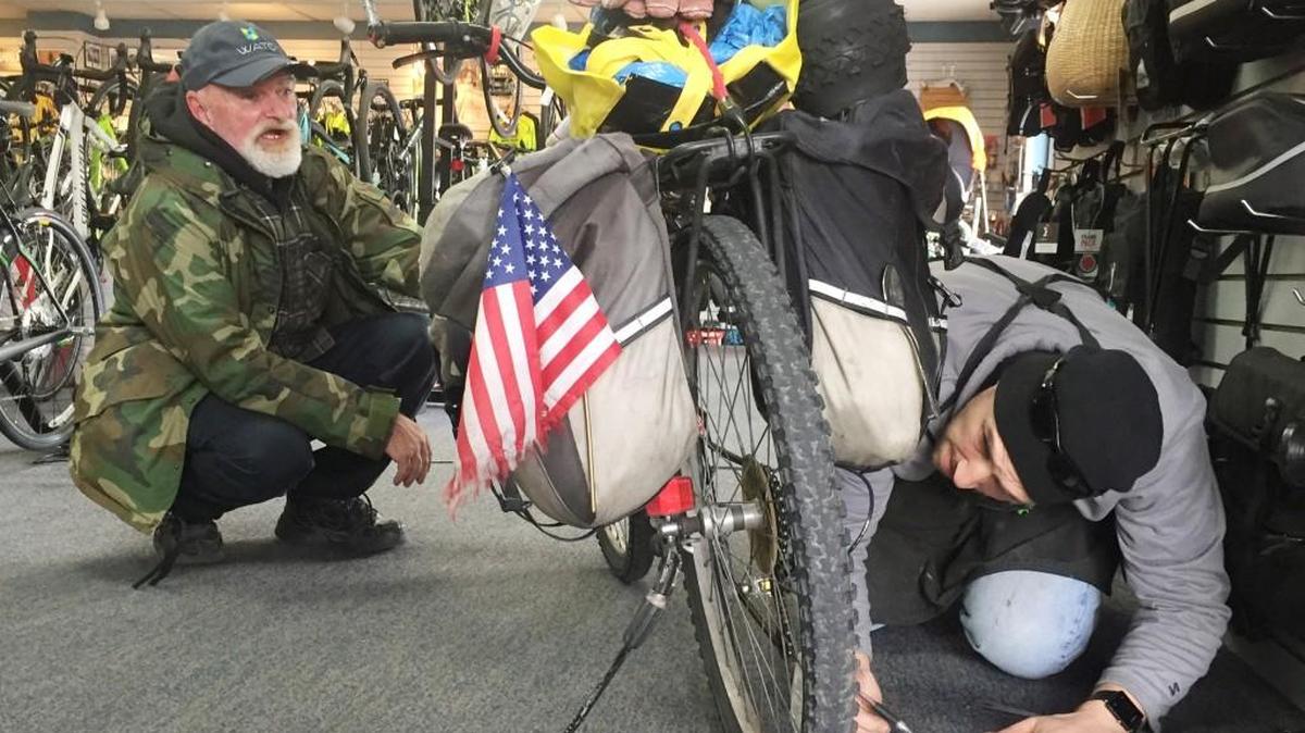 Stirred by the story of how Keith Callison, left, rode his bike from California to look for work, people like Aaron North, service manager at The Bike Pedaler on Rock Road, have been offering him help.