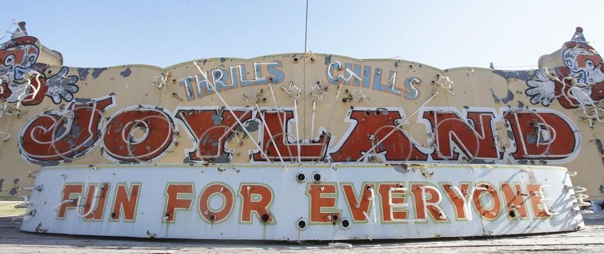 The Historic Preservation Alliance of Wichita and Sedgwick County bought the Joyland entrance sign and plan to restore it. The sign features neon light animation of two clowns.