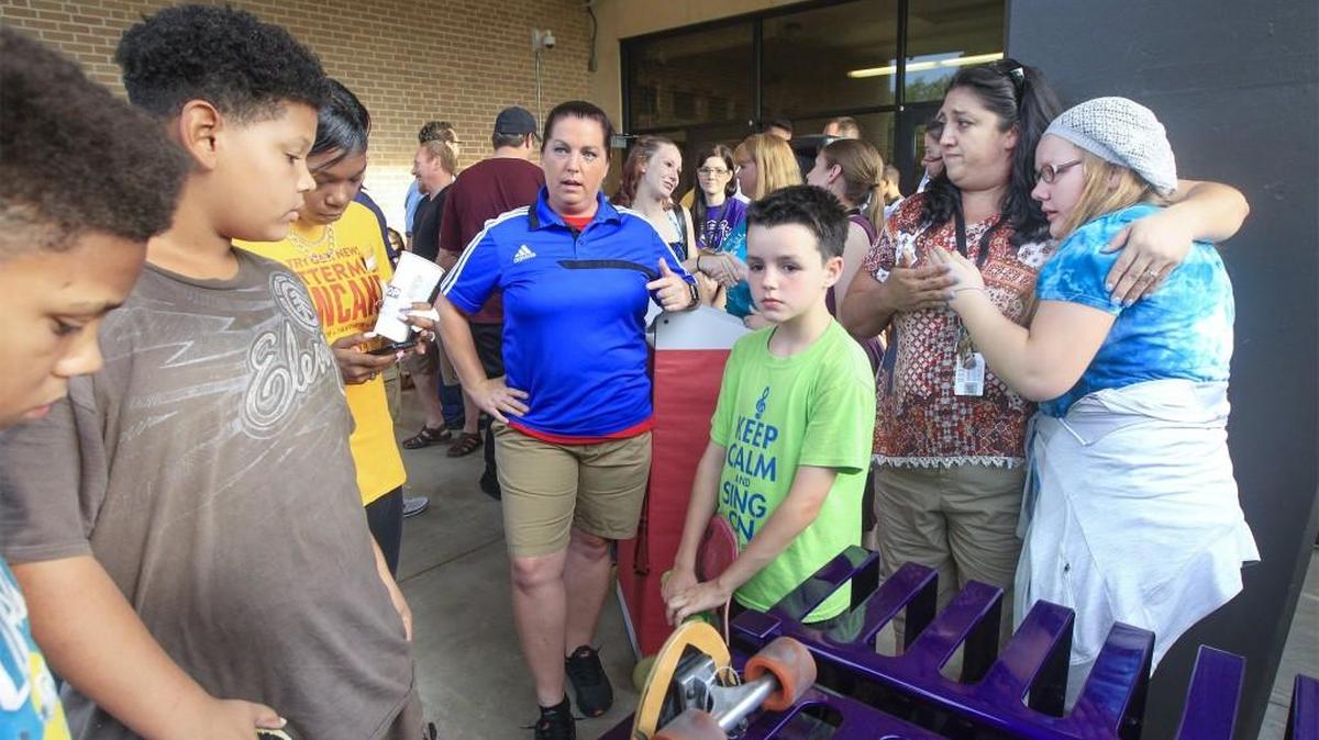 Mead Middle School students gather Tuesday around the new skateboard rack at Mead Middle School honoring Devon Cooley, who drowned in Gypsum Creek earlier this summer. (Aug. 23, 2016)