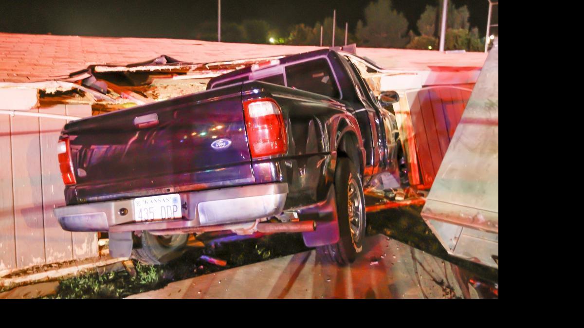 
A pickup rests inside the dugout at a baseball field where the Derby Twins play in Derby after it went out of control, through a fence and knocked over a transformer just as the game ended Tuesday night. (June 23, 2015)
