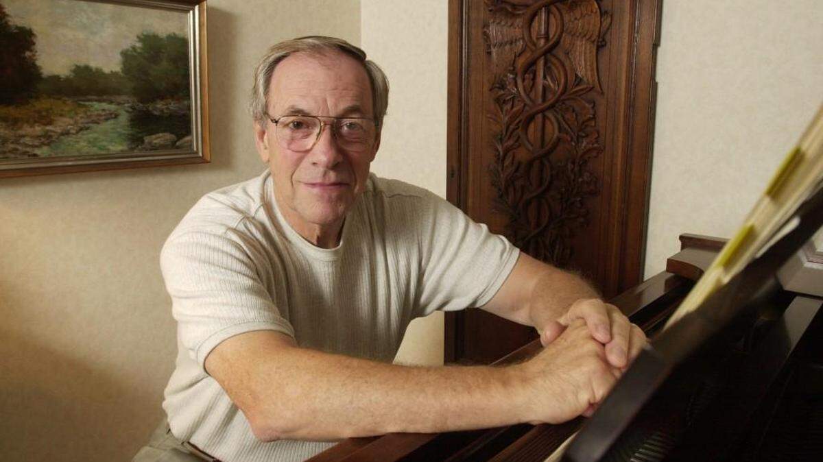 Jay Decker at his home piano which he used to study music. He began playing with the symphony in 1952.