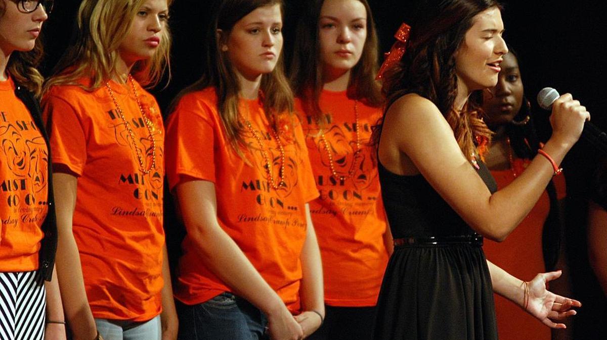 
Isabel Schulte and the Heights High School Choir sing at a Celebration of Life service for Lindsay Crump Perez at Stucky Middle School on Sunday. Mrs. Perez died from complications after giving birth to her first child.
