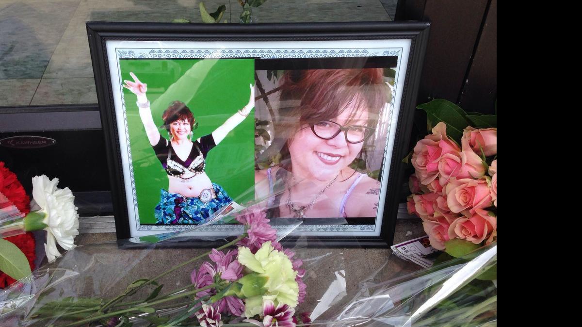 
People have placed flowers and photos at the entrance to Tanya’s Soup Kitchen in memory of Tanya Tandoc, who was killed Thursday. 
