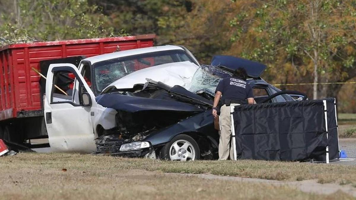 A Wichita crime scene investigator looks over the wreckage of two vehicles on McLean near 15th Street on Monday afternoon. One person died and four others were injured in the crash.