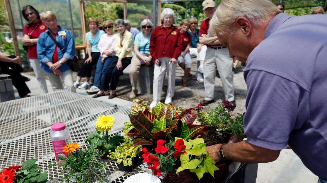 Norman Warminski gives a demonstration to master gardeners on container plants at Tree Top Nursery.