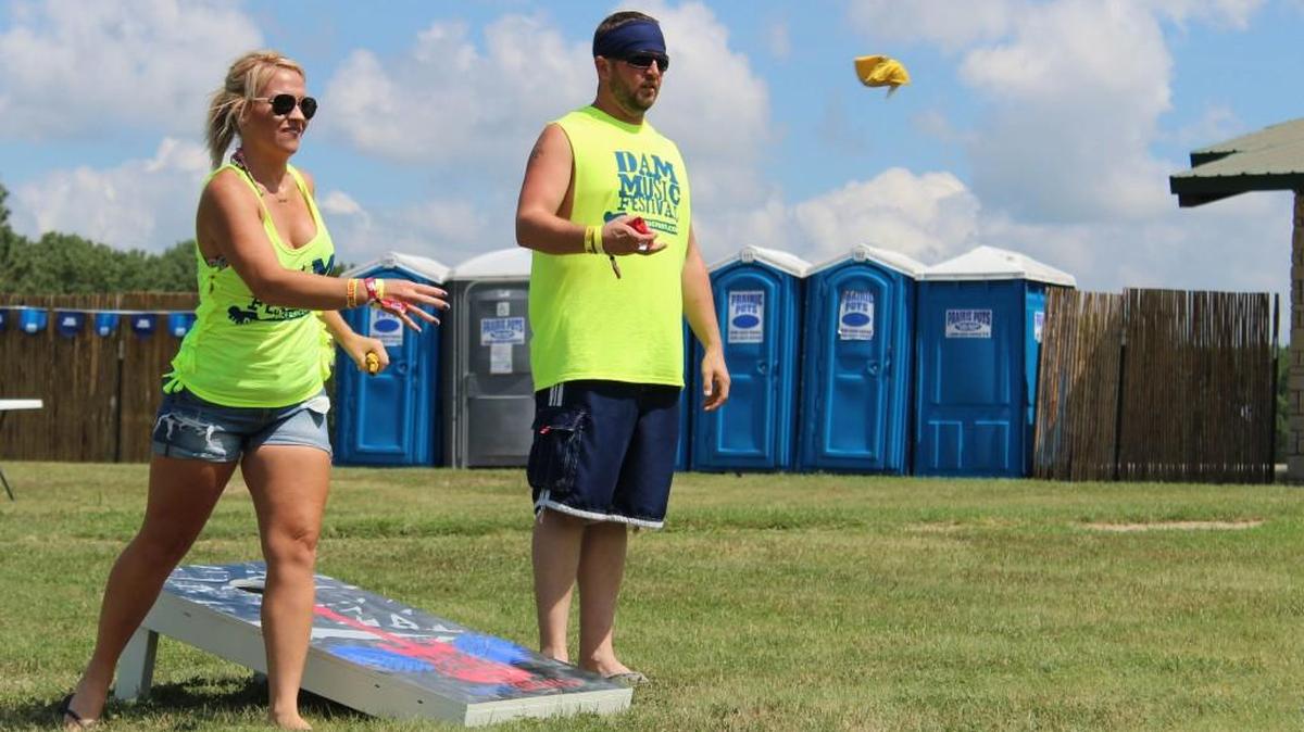 Dam Music Festival staff take a break to play a game of beanbag toss during the Dam Beach Party.