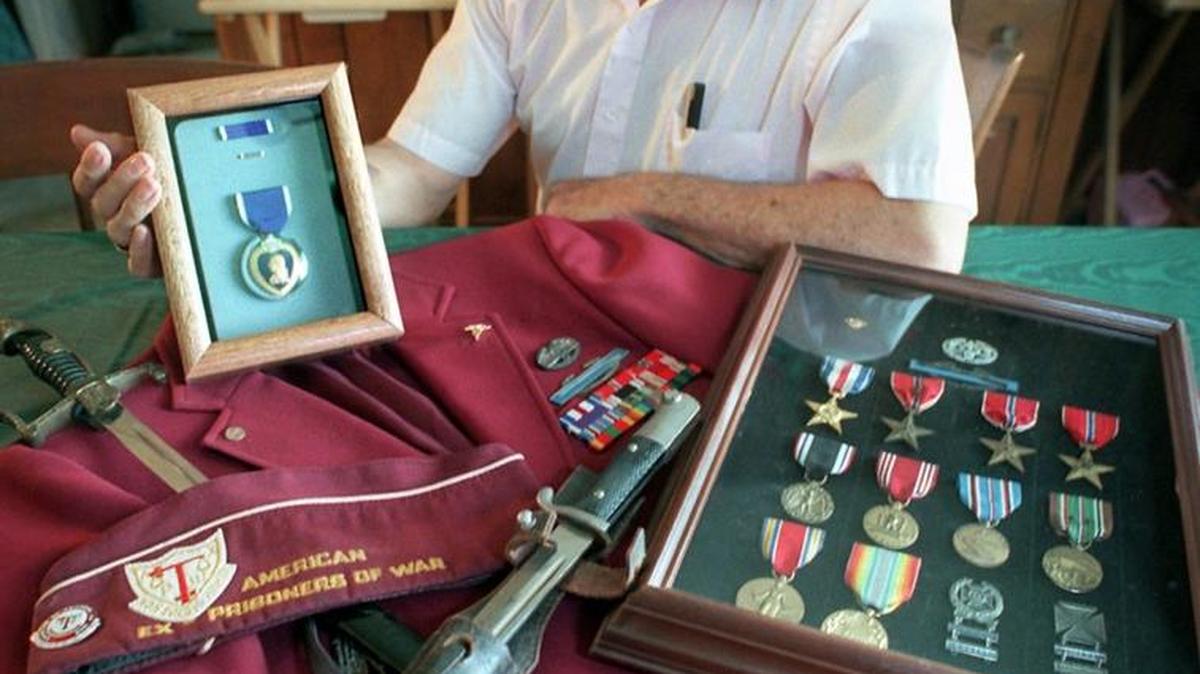 Dr. William Paschal with his Purple Heart and other WWII memorabilia. Dr. Paschal died Friday. He was 91.