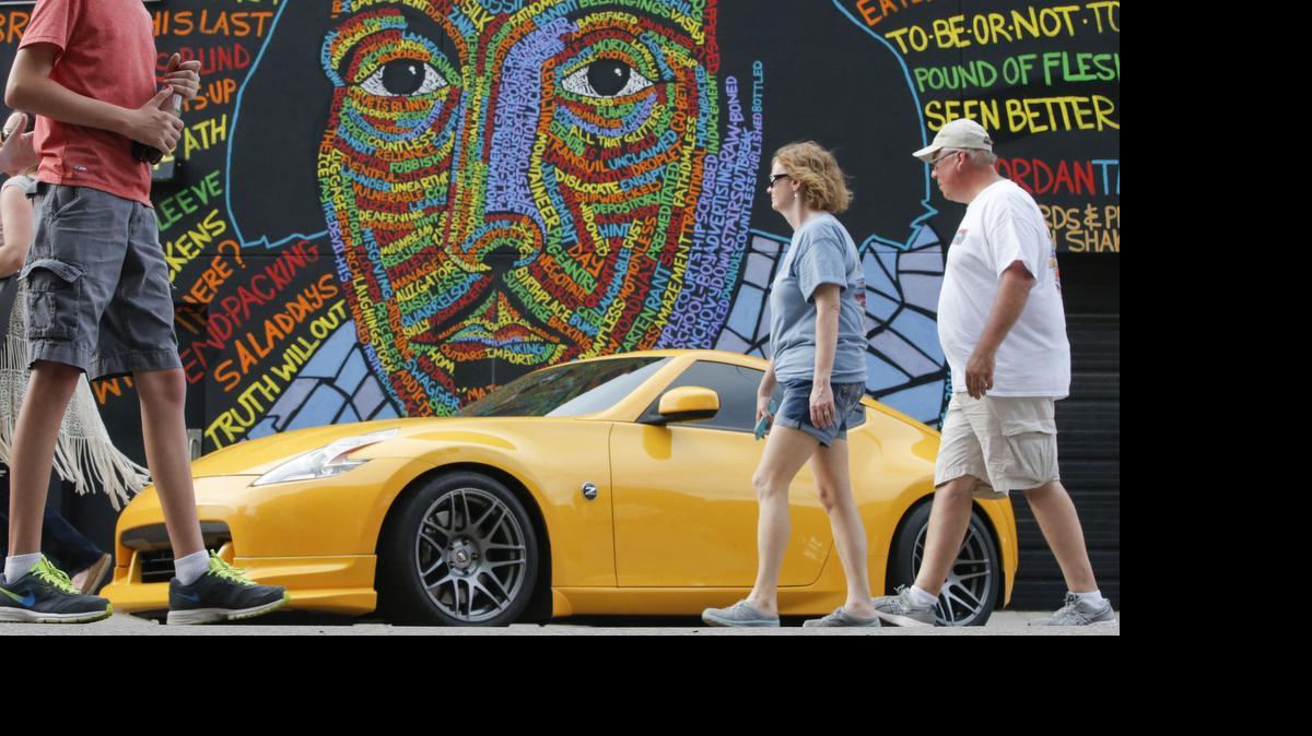 
Car enthusiasts take in the sights Saturday during the 21st annual Automobilia Moonlight Car Show and Street Party in downtown Wichita. (July 11, 2015)
