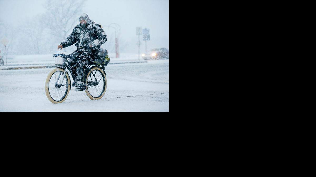 
A bicyclist makes his way down Douglas in downtown Wichita on Saturday evening. (Jan. 3, 2014)
