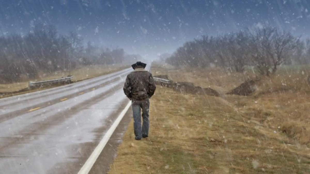 Apache Jay Nesahkluah, a Wichitan who was filmed in the movie “Searching for Home: Coming Back From War,” walks on U.S. 81 near Wellington in the snow.