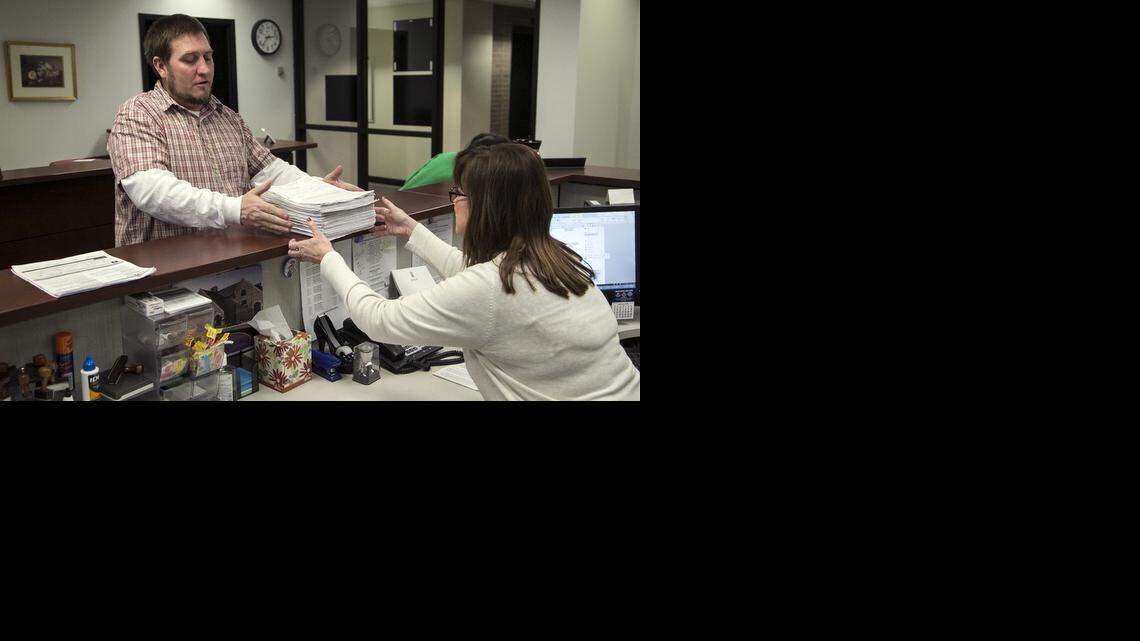 
Esau Freeman, leader of the pro-marijuana group Kansas for Change, hands over a petition to Wichita deputy city clerk Janis Edwards. Backers of the Wichita petition drive to reduce the penalty for marijuana possession say they now have more than enough signatures to put an initiative on the April 7 city election ballot. (Jan.7, 2015)
