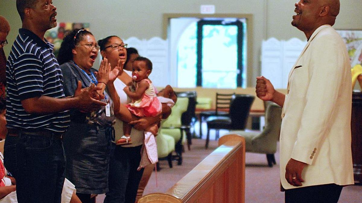 
Senior pastor Junius Dotson sings with the crowd at St. Mark United Methodist Church.

