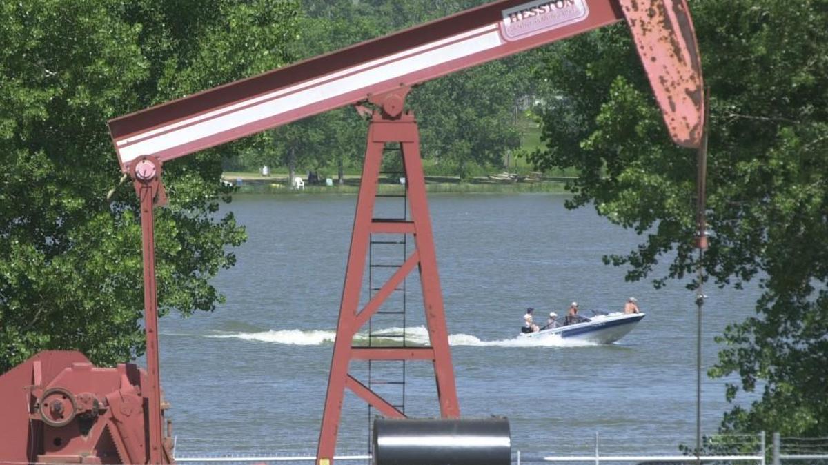 Boaters cruise across Coldwater Lake. A 12-year-old girl’s body was found in the lake on Tuesday.