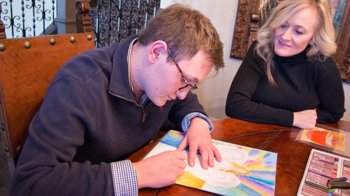 Cole Bullock blends oil pastels on a painting of an angel while his mother, Gina Bullock, offers advice.