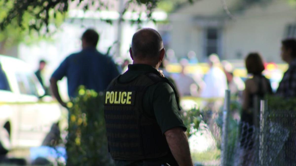 
A Wichita police officer surveys the scene of a fatal shooting Thursday in the 1100 block of South Terrace. 
