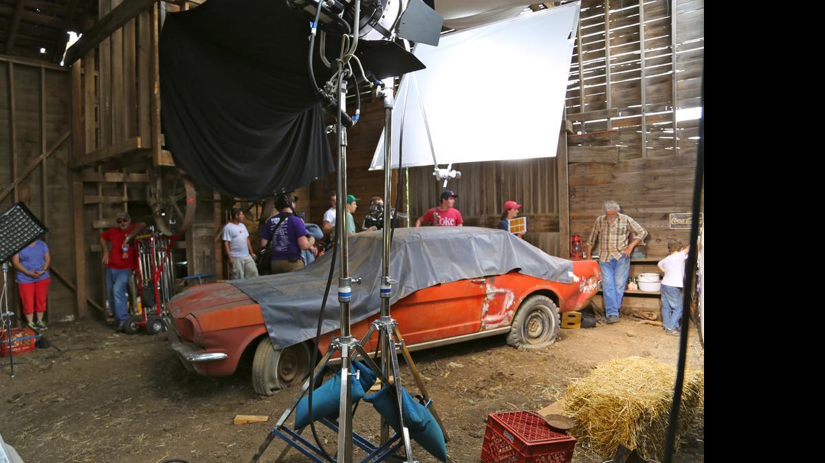 
The cast and crew take a break between takes of a Coca-Cola commercial showing the restoration of a 1965 Ford Mustang last year in a barn near Chapman, Kansas. 

