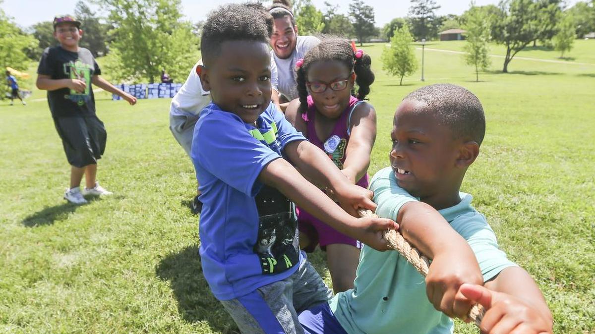 Elijah Lee, right, and Desmond Gunter participate in a tug-of-war at Fairmount Park during a Real Men, Real Heroes community event on Saturday.