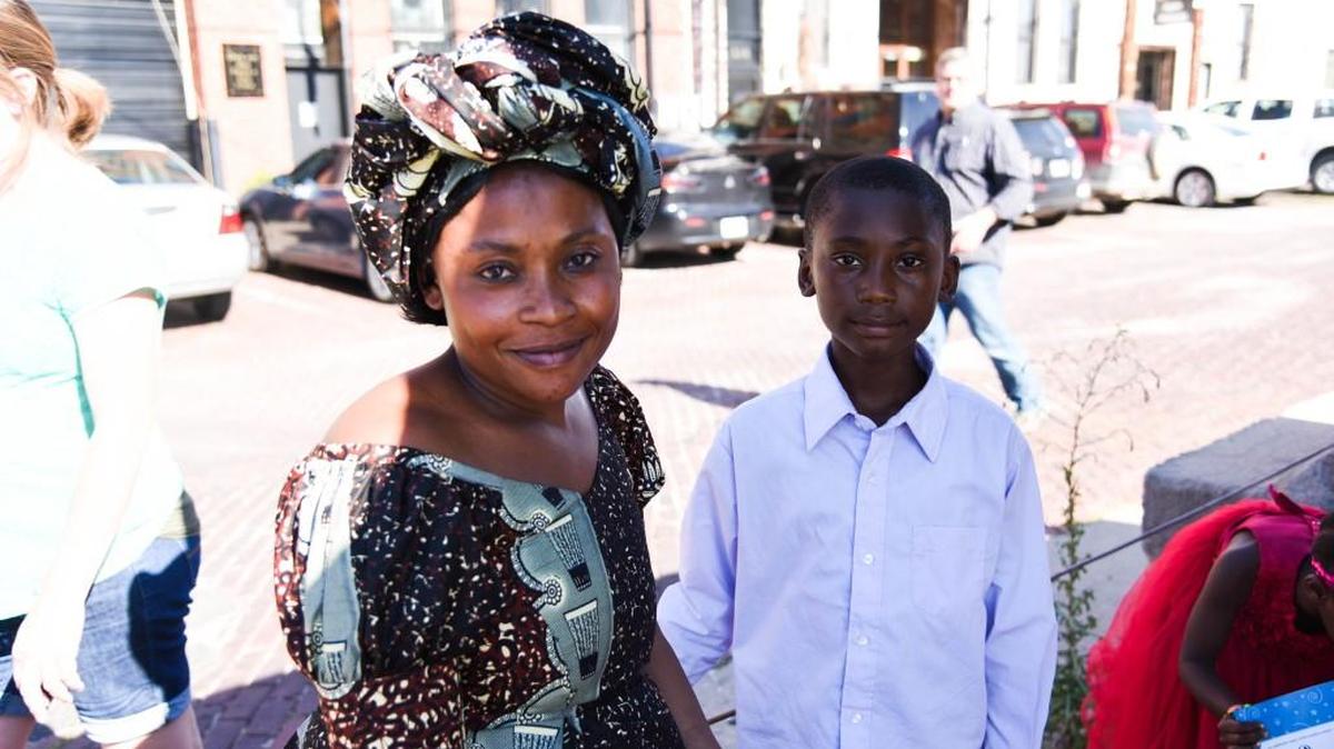Salima Nyasinde and her son Jean Marie Mukabule, 11, sit outside the Shiftspace art exhibit featuring work by refugees resettled in Wichita. Nyasinde and her son came to Wichita from the Congo.