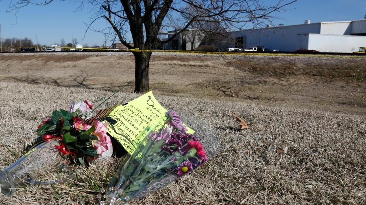 Flowers lie on the roadside near Excel Industries on Friday morning as a makeshift memorial takes shape. Three people were killed and more than a dozen injured after Cedric Ford returned to work Thursday and began shooting. Ford was killed by a police officer. (February 26, 2016)