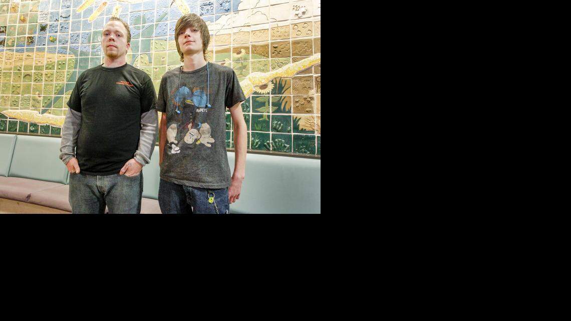 
Kevin Benson, left, and Samuel Carlisle stand in front of the Big Brothers Big Sisters mural in the lobby of their building in downtown Wichita on Thursday. (Feb. 19, 2015)
