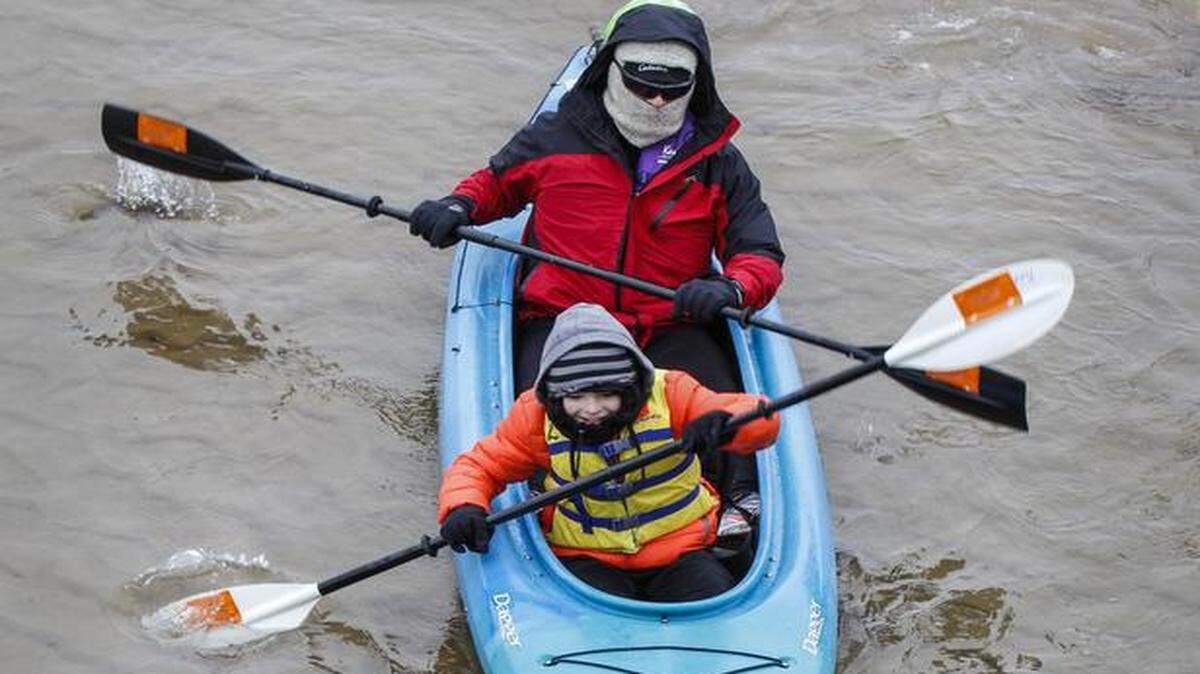 
John Colt, 11, and dad Rob Colt navigate under the John Mack Bridge during the Arkansas River Coalition’s sixth annual New Year’s Day river paddling event. (Jan. 1, 2015)
