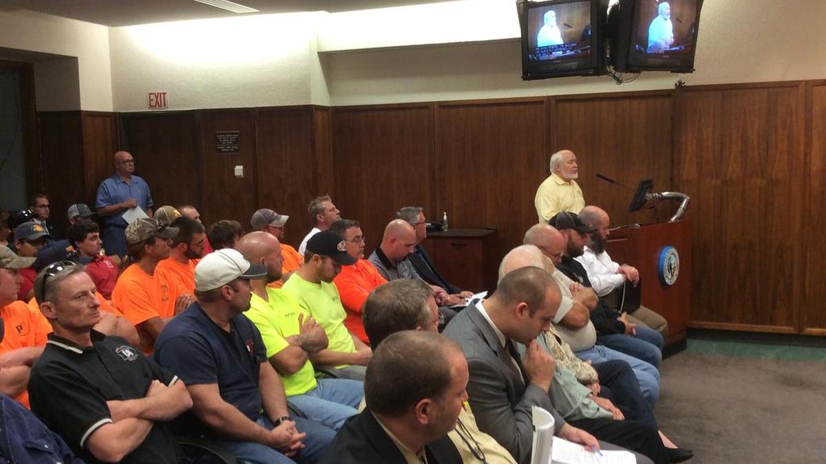 Retired plumber Lonny Wright speaks to Sedgwick County commissioners while other plumbers watch during a Sedgwick County Commission public hearing on plumbing codes on Wednesday.
