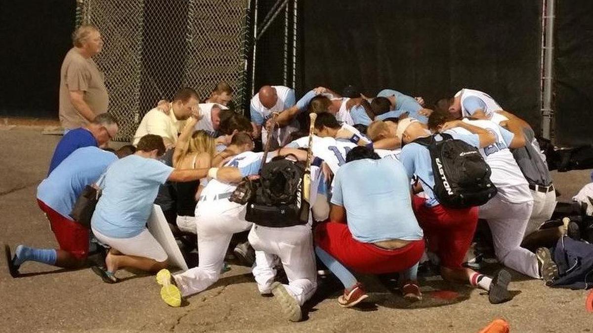 
The Liberal Bee Jays kneel in prayer Sunday after hearing that Kaiser Carlile had died. 
