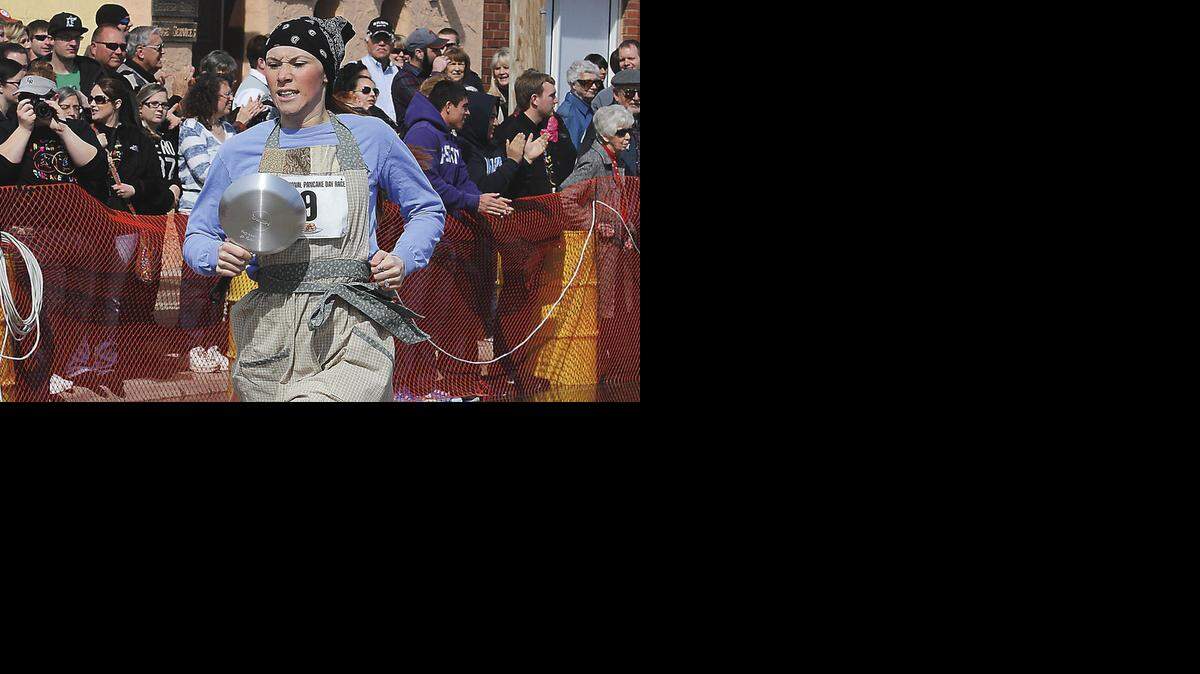 
Summer Parsons crosses the finish line to win the Liberal leg of the International Pancake Day Race with a time of 63.5 seconds in 2014. Olney, England’s Devon Byrne set the world record with a time of 55.61 seconds for the 400-yard, S-shaped course. 
