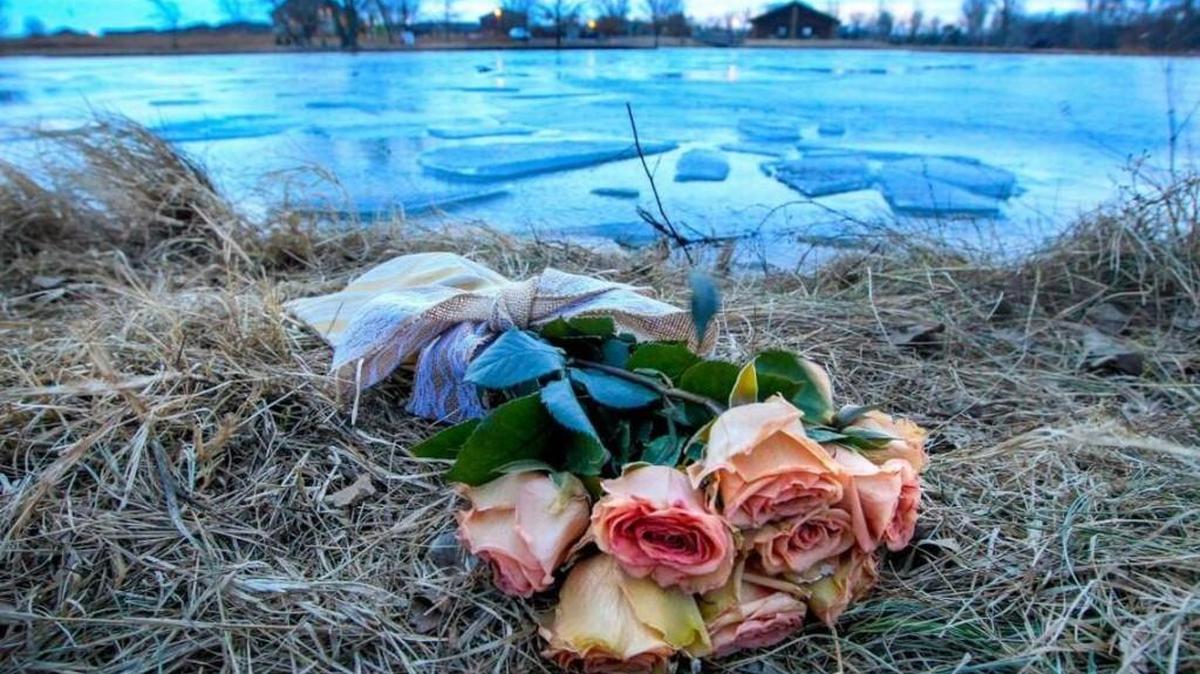 Flowers on the shore of the pond in William P. Pack Memorial Park in Moundridge, where a woman and her son died after falling through the ice on the first Friday of 2017.