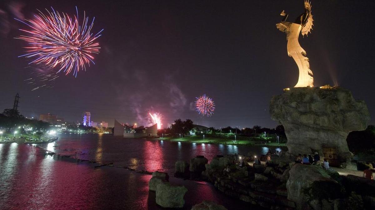 Fireworks explode over downtown Wichita and the Keeper of the Plains.